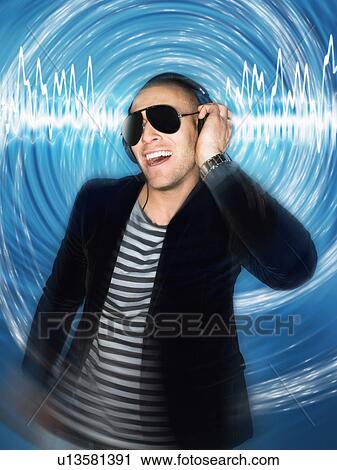 Man wearing headphones in front of circular effect half-length View Large Photo Image Stock Image - Man wearing headphones in front of circular effect half-length. Fotosearch