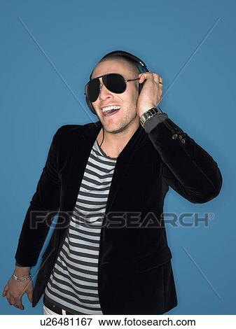 Man wearing headphones in studio half-length View Large Photo Image Stock Photo - Man wearing headphones in studio half-length. Fotosearch