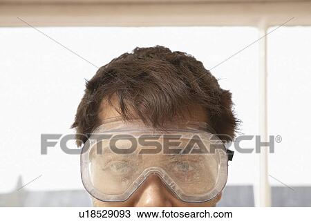 Man wearing protective eye goggles indoors close up high section View Large Photo Image Stock Image - Man wearing protective eye goggles indoors close up high section. Fotosearch
