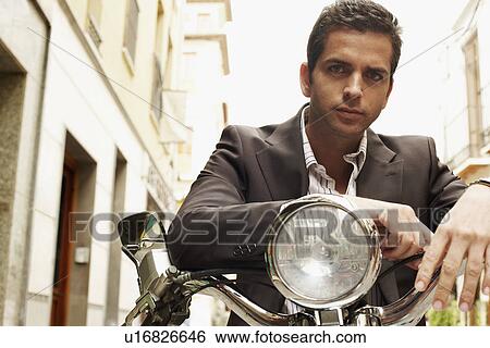 Man wearing suit sitting on motorcycle front view portrait. View Large Photo Image Stock Photograph - Man wearing suit sitting on motorcycle front view portrait.. Fotosearch