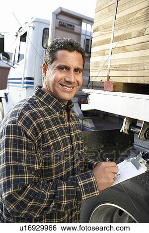 Man with clipboard by truck loaded with wood View Large Photo Image Stock Photograph - Man with clipboard by truck loaded with wood. Fotosearch