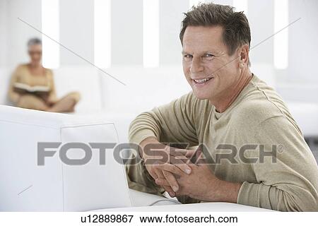 Married Couple Relaxing in Living Room View Large Photo Image Stock Photo - Married Couple Relaxing in Living Room. Fotosearch