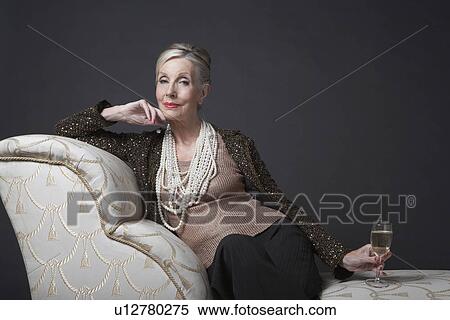 Mature Woman Having Glass of Champagne View Large Photo Image Stock Photography - Mature Woman Having Glass of Champagne. Fotosearch