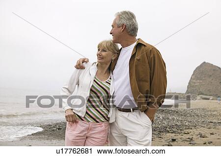 Middle-aged couple embracing on beach View Large Photo Image Stock Image - Middle-aged couple embracing on beach. Fotosearch