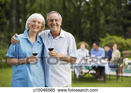 Middle-aged couple in back yard with glasses of wine portrait View Large Photo Image Stock Photography - Middle-aged couple in back yard with glasses of wine portrait. Fotosearch
