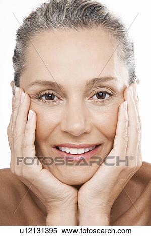 Stock Photography - Middle-Aged Woman head in hands. Fotosearch