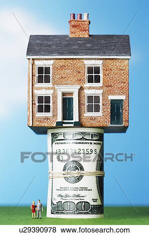 Stock Photo - Model house on roll of $100 notes. Fotosearch