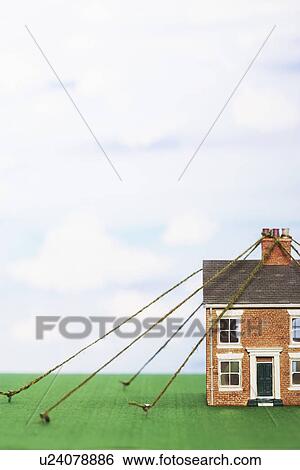 Model house tied down with string View Large Photo Image Stock Photograph - Model house tied down with string. Fotosearch