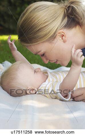 Mother and baby on rug in garden View Large Photo Image Stock Photo - Mother and baby on rug in garden. Fotosearch