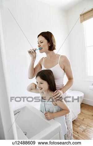 Mother and Daughter Brushing Teeth in bathroom View Large Photo Image Stock Photo - Mother and Daughter Brushing Teeth in bathroom. Fotosearch