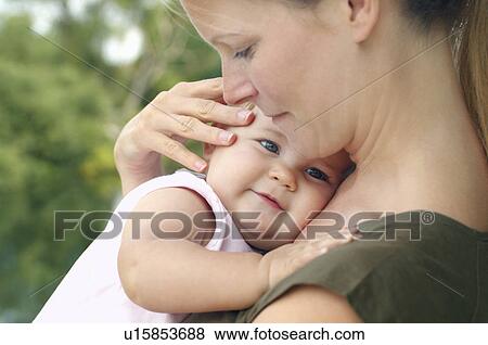 Stock Photo - Mother holding daughter close up. Fotosearch