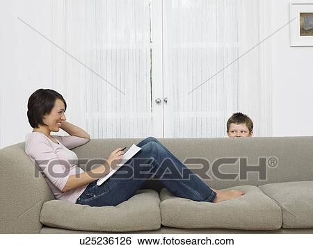Mother using cell phone young son watching View Large Photo Image Stock Photograph - Mother using cell phone young son watching. Fotosearch