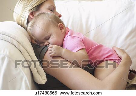 Mother with baby sleeping on sofa View Large Photo Image Stock Photography - Mother with baby sleeping on sofa. Fotosearch