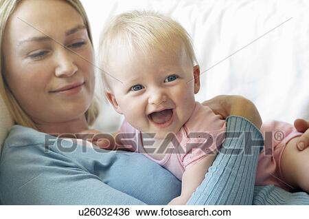 Mother with daughter on sofa View Large Photo Image Stock Photograph - Mother with daughter on sofa. Fotosearch