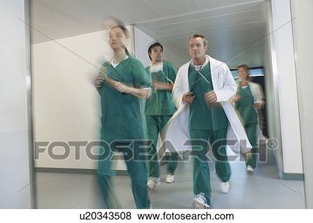 Motion blur image of small group of doctors and nurses in scrubs running through hospital corridor View Large Photo Image Stock Photo - Motion blur image of small group of doctors and nurses in scrubs running through hospital corridor. Fotosearch