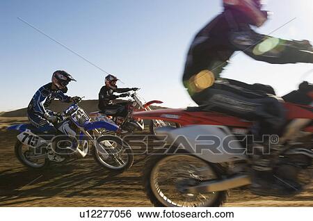 Stock Photograph - Motocross race in desert. Fotosearch
