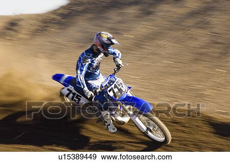 Motocross racer on dirt track View Large Photo Image Stock Photo - Motocross racer on dirt track. Fotosearch