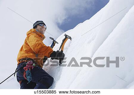 Mountain climber going up snow with axes View Large Photo Image Stock Photography - Mountain climber going up snow with axes. Fotosearch