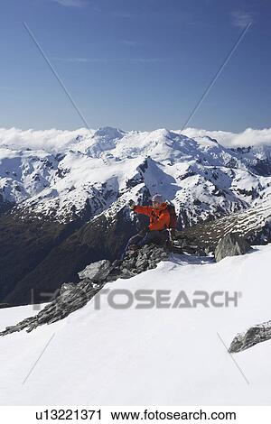Mountain climber taking a picture on mountain peak View Large Photo Image Stock Image - Mountain climber taking a picture on mountain peak. Fotosearch