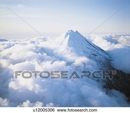 Mountain peak above clouds View Large Photo Image Stock Photograph - Mountain peak above clouds. Fotosearch