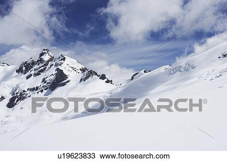 Mountain peaks beneath snow View Large Photo Image Stock Image - Mountain peaks beneath snow. Fotosearch