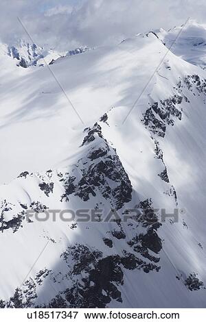 Stock Photo - Mountain peaks beneath snow. Fotosearch
