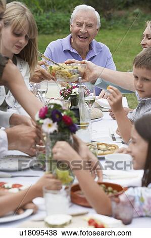 Multigenerational family dining in garden View Large Photo Image Stock Photo - Multigenerational family dining in garden. Fotosearch