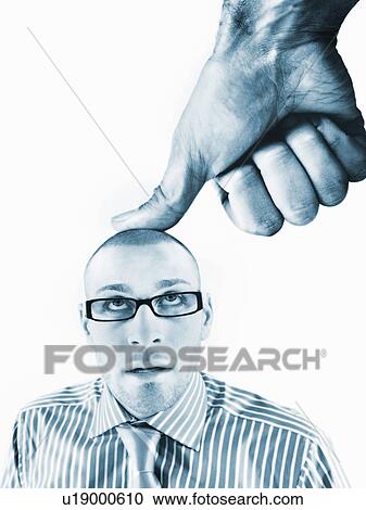 Stock Image - Office worker being bushed by large thumb. Fotosearch