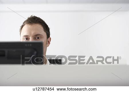 Office worker using computer in office cubicle View Large Photo Image Picture - Office worker using computer in office cubicle. Fotosearch
