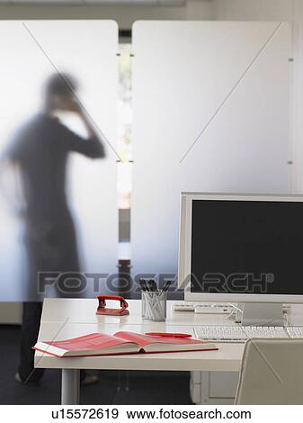 Stock Photo - Office Worker Using Telephone Behind Partition. Fotosearch