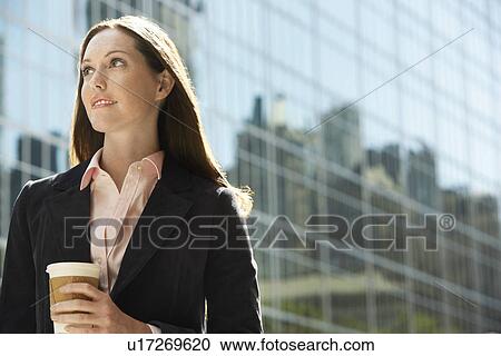 Office worker with drink outside office building portrait View Large Photo Image Stock Image - Office worker with drink outside office building portrait. Fotosearch