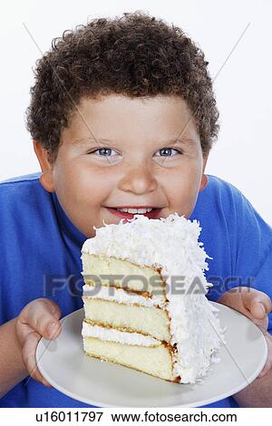 Overweight boy (13-15) holding Large Slice of Cake smiling portrait View Large Photo Image Stock Photo - Overweight boy (13-15) holding Large Slice of Cake smiling portrait. Fotosearch