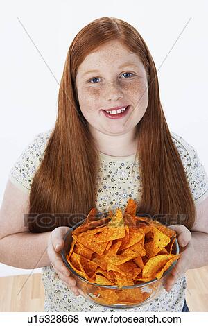 Overweight girl (13-15) holding bowl of snacks portrait View Large Photo Image Stock Photo - Overweight girl (13-15) holding bowl of snacks portrait. Fotosearch