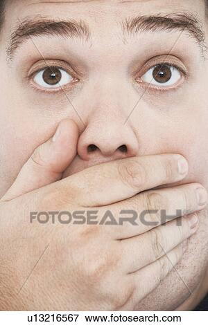 Overweight Man with Hand on Mouth and raised eyebrows portrait close up View Large Photo Image Stock Photo - Overweight Man with Hand on Mouth and raised eyebrows portrait close up. Fotosearch