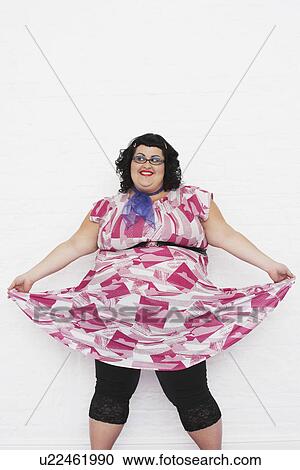 Stock Image - Overweight woman curtseying portrait. Fotosearch