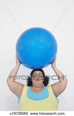 Overweight Woman Holding Exercise Ball on head View Large Photo Image Stock Photography - Overweight Woman Holding Exercise Ball on head. Fotosearch