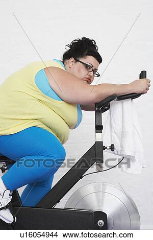 Overweight Woman on Exercise Bike View Large Photo Image Picture - Overweight Woman on Exercise Bike. Fotosearch