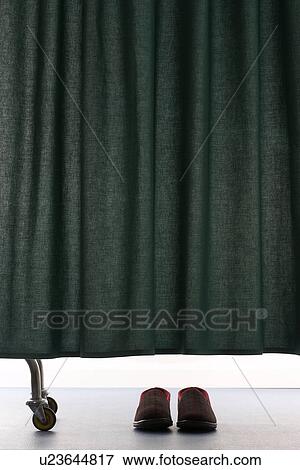 Pair of shoes under curtain in hospital View Large Photo Image Stock Photo - Pair of shoes under curtain in hospital. Fotosearch