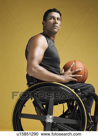 Paraplegic athlete sitting in wheelchair holding basketball side view View Large Photo Image Stock Image - Paraplegic athlete sitting in wheelchair holding basketball side view. Fotosearch