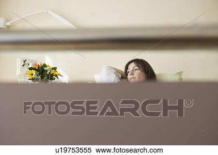 Stock Photography - Patient Resting in Hospital Bed seen through bed handle. Fotosearch