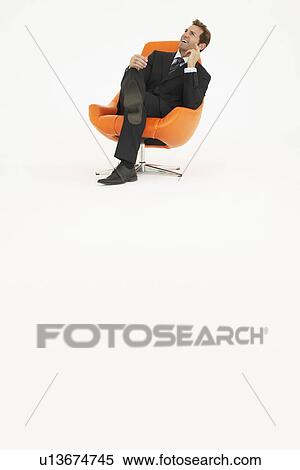 Pensive businessman sitting in chair on white background View Large Photo Image Stock Photography - Pensive businessman sitting in chair on white background. Fotosearch