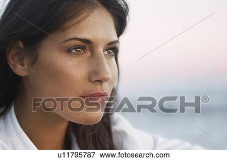 Pensive Woman on Beach looking out to sea head shot close up View Large Photo Image Stock Photo - Pensive Woman on Beach looking out to sea head shot close up. Fotosearch