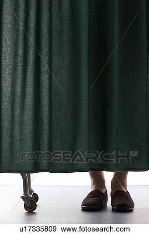 Person behind curtain in hospital low section View Large Photo Image Stock Photo - Person behind curtain in hospital low section. Fotosearch
