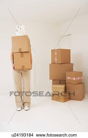 Person carrying moving boxes View Large Photo Image Picture - Person carrying moving boxes. Fotosearch