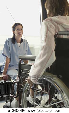 Physician Listening to Patient in wheelchair View Large Photo Image Picture - Physician Listening to Patient in wheelchair. Fotosearch