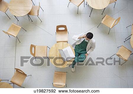 Physician Using Laptop in cafeteria view from above View Large Photo Image Stock Image - Physician Using Laptop in cafeteria view from above. Fotosearch