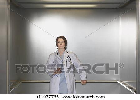 Physician Waiting in Elevator portrait View Large Photo Image Stock Photography - Physician Waiting in Elevator portrait. Fotosearch