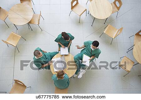 Physicians Consulting in Cafeteria view from above View Large Photo Image Stock Photography - Physicians Consulting in Cafeteria view from above. Fotosearch