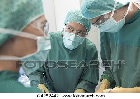 Physicians in Surgery operating on patient View Large Photo Image Stock Image - Physicians in Surgery operating on patient. Fotosearch