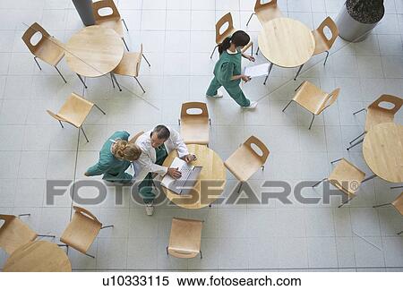 Stock Photography - Physicians talking in cafeteria view from above. Fotosearch